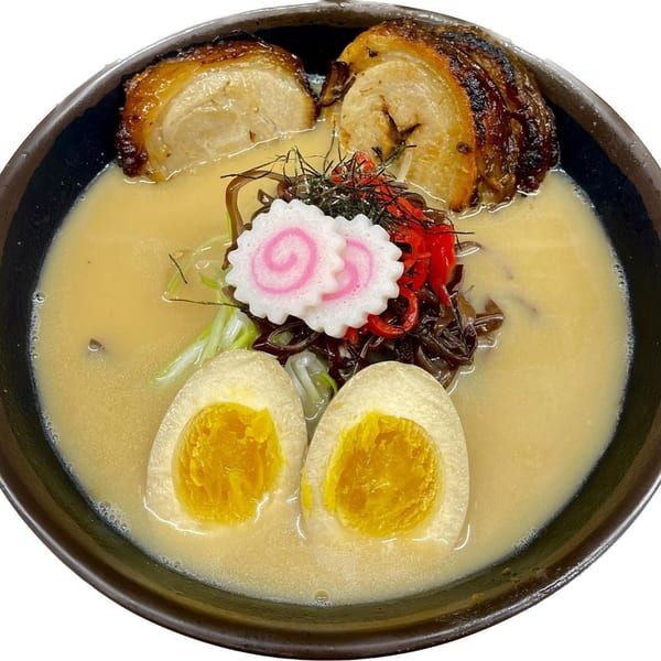 Madden Ramen's tonkotsu ramen with pork belly, soft-boiled eggs, narutomaki, and other toppings.